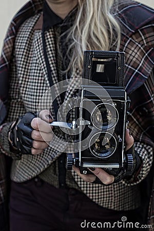 Girl in vintage clothes with old camera Stock Photo