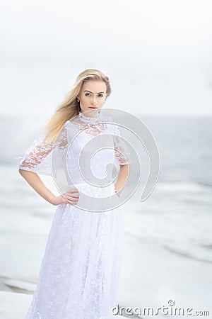 girl in a vintage dress on a river in winter Stock Photo
