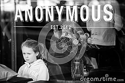 Girl waits for order alone at a cafe looking sad and alone Editorial Stock Photo