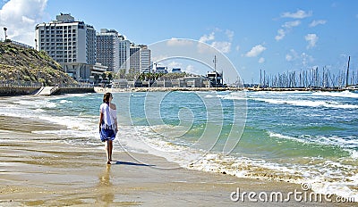 Girl walking along the seashore. Editorial Stock Photo