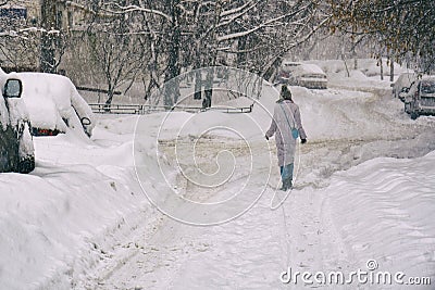 Girl walking along a snowbound Moscow street in February Stock Photo