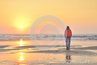 Girl walking on beach at sunset. Editorial Stock Photo