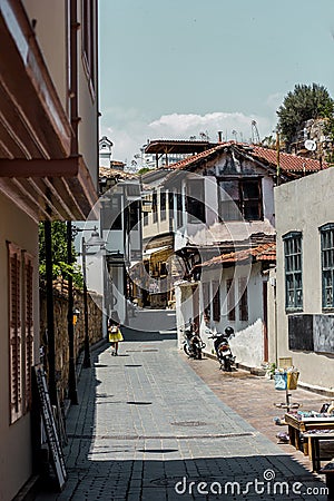 Girl walking down the sunny street of old town Kaleici, Antalya, Turkey Stock Photo