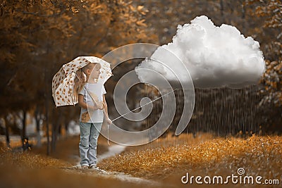 A girl walking the rainy cloud at autumn time on the orange background Stock Photo