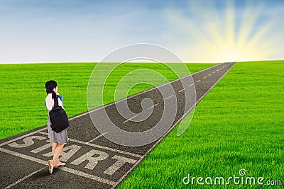 Girl walking on the road to start her future Stock Photo