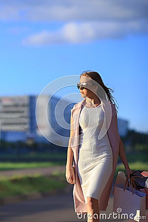 Girl walking with shopping bags. Concept of woman shopping.Shopper. Sales Stock Photo