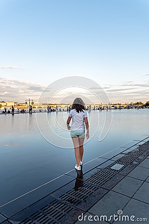 Girl walking on Water Mirror in Bordeaux Stock Photo