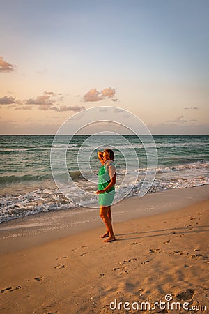 Girl walks along the beach in a dress Stock Photo