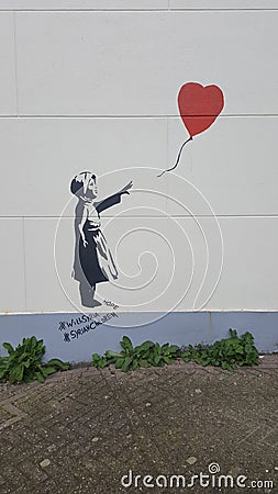Banksy graffiti of girl with balloon Editorial Stock Photo