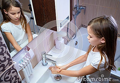 Girl washing of hands soap foam and water. hygiene Stock Photo