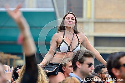 A girl watches a concert sitting on the shoulders of her boyfriend Editorial Stock Photo