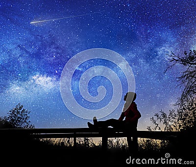 Girl watching the stars in night sky Stock Photo