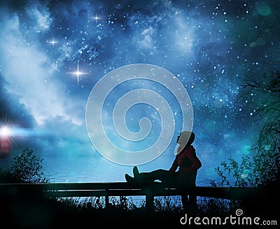 Girl watching the stars in night sky Stock Photo