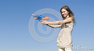 Girl with a water pistol Stock Photo