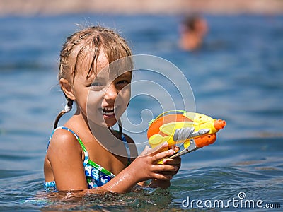 Girl with water pistol Stock Photo