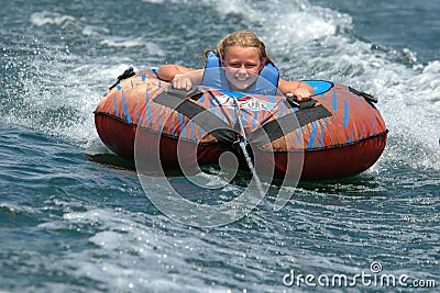 Girl Water Tubing with a Smile Stock Photo