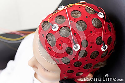 Girl wearing headgear during a session of biofeedback therapy Stock Photo