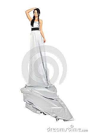 Girl wearing long silver dress looks proudly Stock Photo