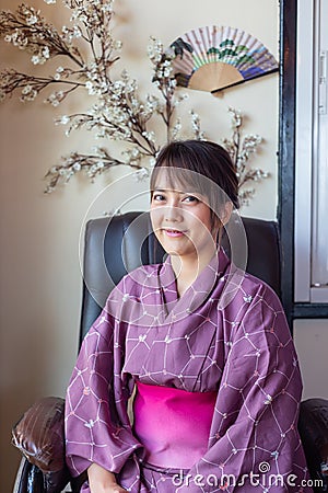 The girl is wearing a pink traditional yukata, which is the national dress Stock Photo