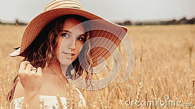 Girl wheat field summer. Happy young woman in sun hat in summer wheat field at sunset. Nature, summer holidays, vacation Stock Photo