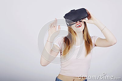 Girl on a white background plays virtual reality. Games and films vr. Emotions Stock Photo