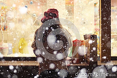 Girl at the window of Christmas shop Stock Photo