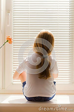 Girl on window-sill Stock Photo