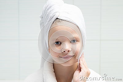 Girl wipes her face with a cotton pad Stock Photo