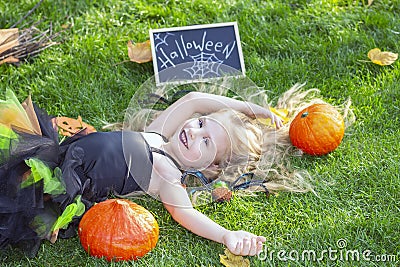 Girl in a witch costume for the Halloween holiday. Stock Photo