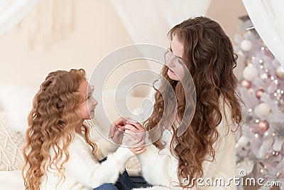 girl and woman congratulating happy new year in home at badroom Stock Photo