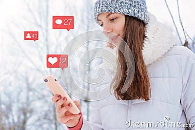 Caucasian girl woman holds phone instagram social media bloger icon followers likes comments addicted concept Stock Photo