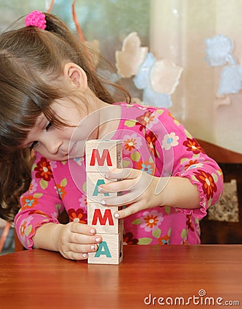 The girl and word mama from cubes Stock Photo