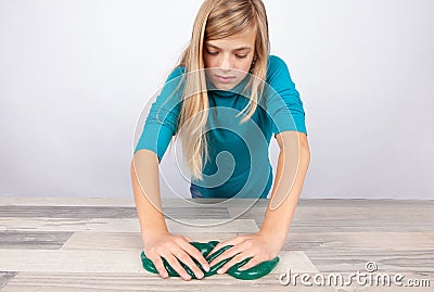 Girl working with slime on a table Stock Photo