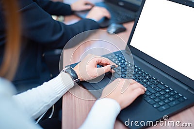 The girl works at a laptop in the office. Hands with laptop close up Stock Photo