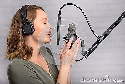 The girl works in a recording studio. Sound recording, and news. News report Stock Photo