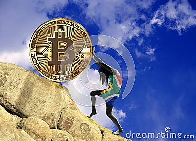 The girl, wrapped in the flag of South Africa, raises a bitcoin coin up the hill Stock Photo