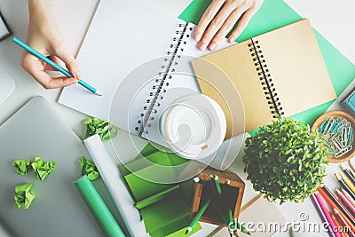 Girl writing in spiral notepad Stock Photo