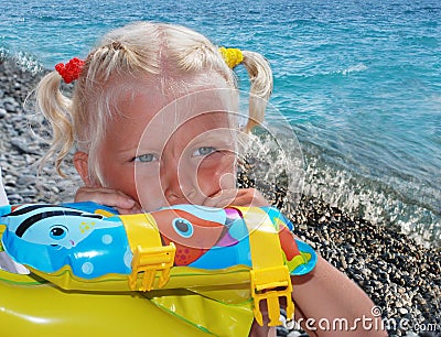 The girl of 3 years, the blonde, on a sea beach Stock Photo