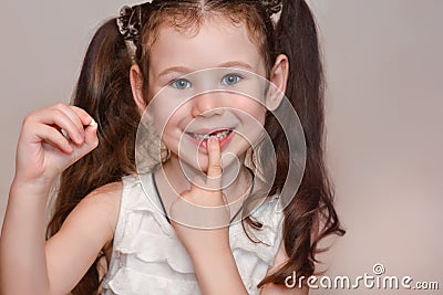 Girl 6 years old holds a tooth in her hand, which she lost Stock Photo