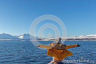 Girl in yellow Enjoying a fjords cruise Stock Photo