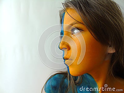 Girl with yellow face body art Stock Photo