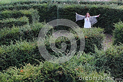 Girl in a yew maze Stock Photo