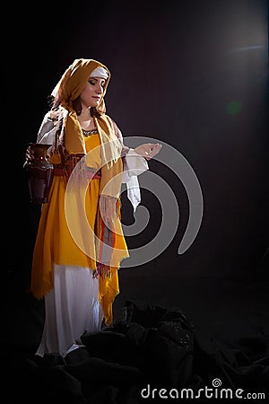 A girl or a young woman from ancient Israel, Palestine, Iran, Iraq with a clay jug. A biblical story with Rebekah and Stock Photo