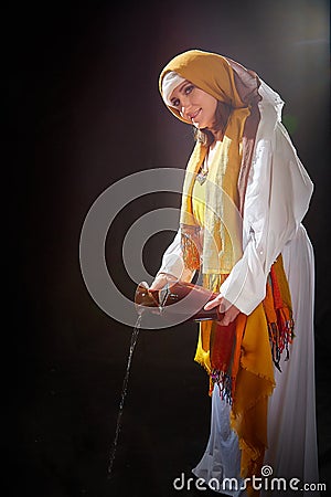 A girl or a young woman from ancient Israel, Palestine, Iran, Iraq with a clay jug. A biblical story with Rebekah and Stock Photo