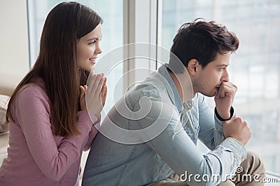 Girlfriend apologizing, asking for forgiveness serious upset boy Stock Photo