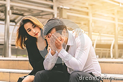 Girlfriend giving Consolation to a stressed boyfrined office Stock Photo