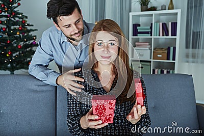 Girlfriend looks sceptical to her christmas gift Stock Photo