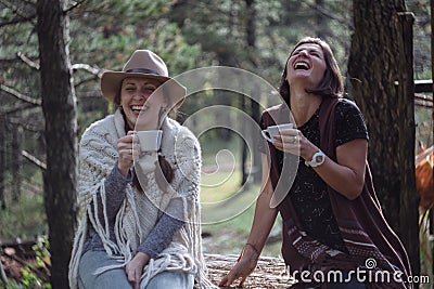 Girlfriends drinking coffee on nature in the country. Folk style Stock Photo