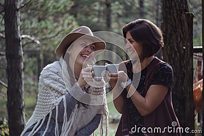 Girlfriends drinking coffee on nature in the country. Folk style Stock Photo