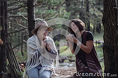 Girlfriends drinking coffee on nature in the country. Folk style Stock Photo